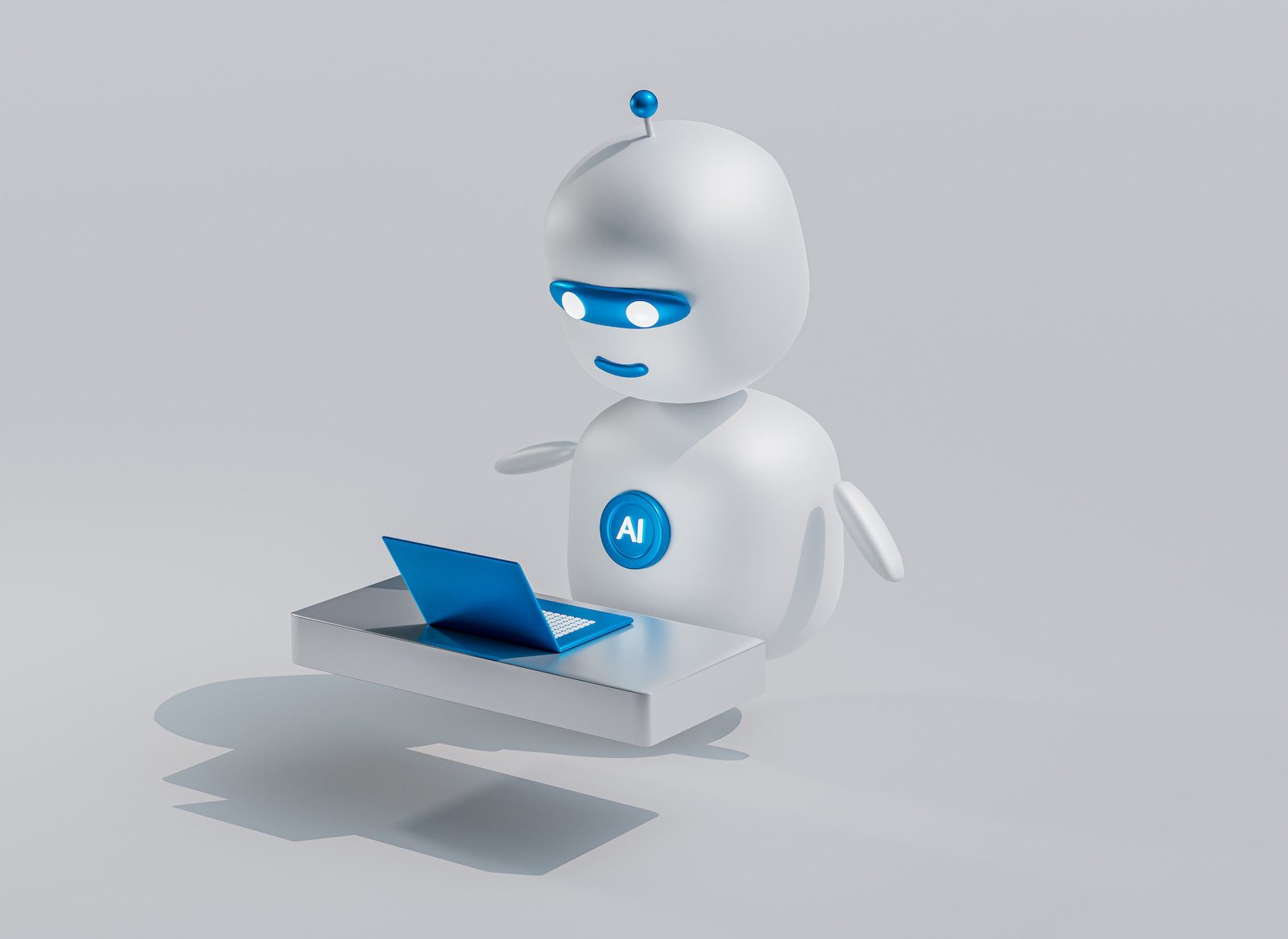 a white robot with blue eyes and a laptop