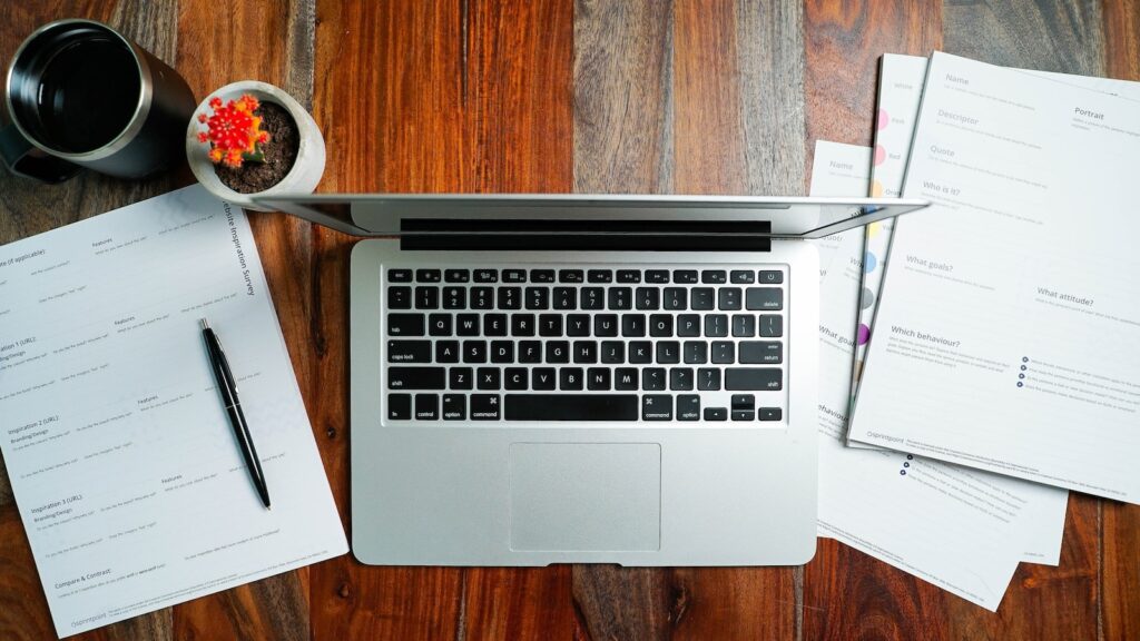 a laptop computer sitting on top of a wooden desk