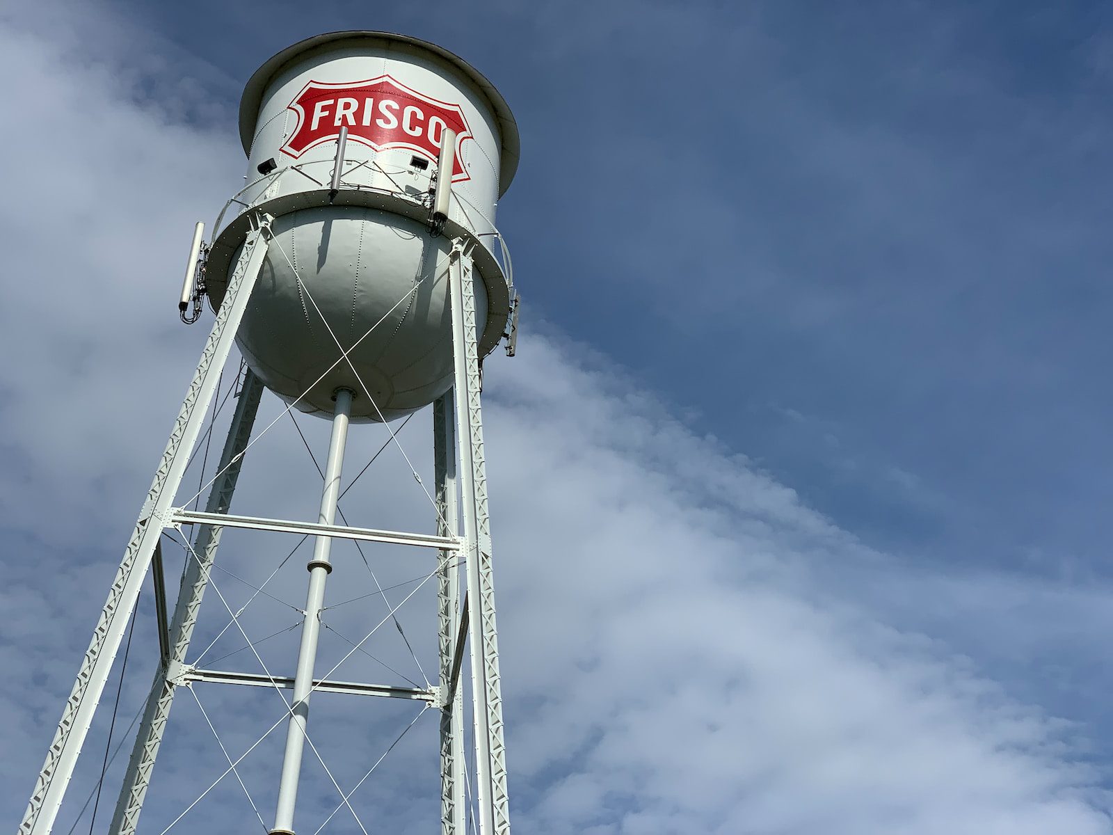 white and red water tank under blue sky during daytime