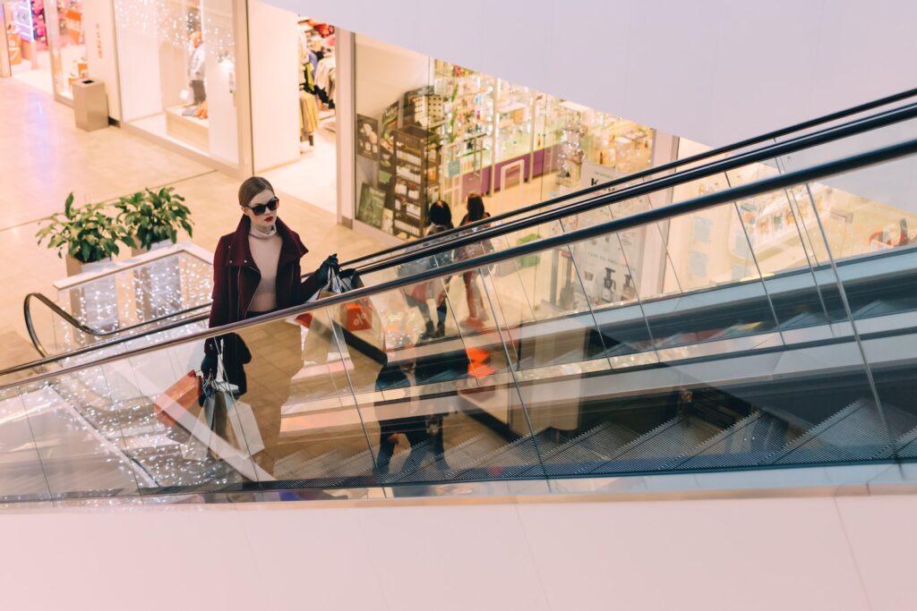 woman riding escalator